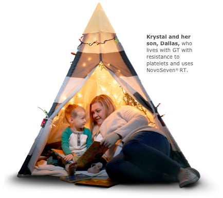 Mother and son in a tent with a string of lights reading